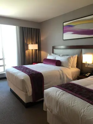 a hotel room with two beds and two lamps at Parkwest Bicycle Casino in Bell Gardens
