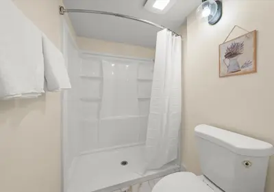 a white bathroom with a shower and a toilet at Cozy&Stylish DT Alhambra Living walk to Starbucks in Alhambra