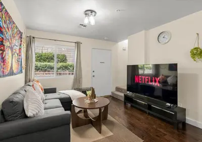 a living room with a couch and a tv at Cozy&Stylish DT Alhambra Living walk to Starbucks in Alhambra