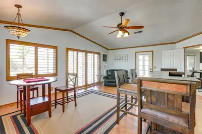 a kitchen and living room with a ceiling fan at Pool, Spa and Mountain Views Apple Valley Retreat! in Apple Valley