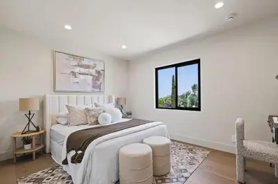 a white bedroom with a large bed and a window at The Dona Modern in Los Angeles