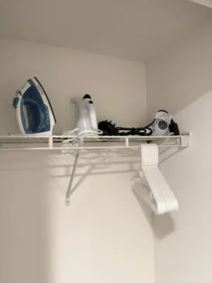 a white shelf with shoes and other items on it at The Hollywood Blvd Loft FREE AND DESIGNATED PARKING in Los Angeles