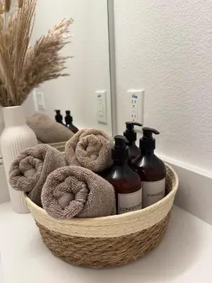 a basket with two bottles of soap and towels at The Hollywood Blvd Loft FREE AND DESIGNATED PARKING in Los Angeles