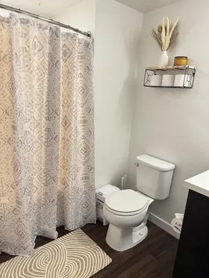 a bathroom with a toilet and a shower curtain at The Hollywood Blvd Loft FREE AND DESIGNATED PARKING in Los Angeles