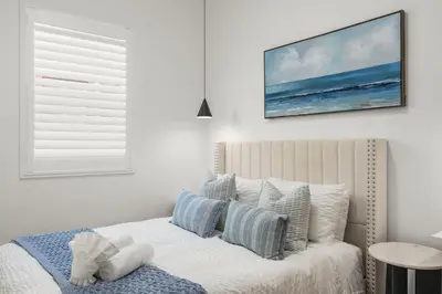 a bedroom with a bed with a picture on the wall at #Marbella Lane - Cityside Haven with Touch of Charm in Compton