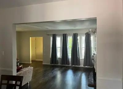 a living room with black drapes on the window at Northridge 3BR 2BA Home with Pool on a Tree-Lined street, Close to CSUN in Northridge