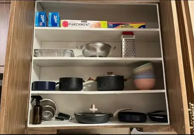 a shelf with pots and pans and other kitchen items at Northridge 3BR 2BA Home with Pool on a Tree-Lined street, Close to CSUN in Northridge