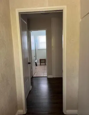 an empty hallway with a door leading to a room at Northridge 3BR 2BA Home with Pool on a Tree-Lined street, Close to CSUN in Northridge