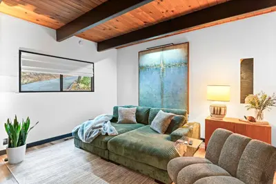 a living room with a couch and a table at BlackOak Hideaway in Lake Arrowhead