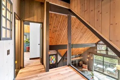 an open staircase in a house with a wooden ceiling at BlackOak Hideaway in Lake Arrowhead