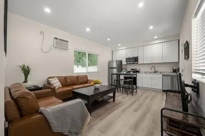 a living room with a couch and a kitchen at Stay on Hart in Los Angeles