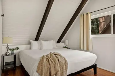 a bedroom with a white bed and a window at The Mountain Sanctuary in Lake Arrowhead