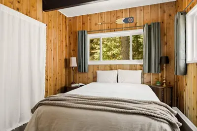 a bedroom with a bed and a window at The Mountain Sanctuary in Lake Arrowhead