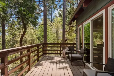 a dog sitting on the porch of a house at The Mountain Sanctuary in Lake Arrowhead