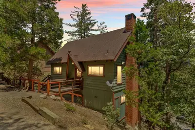 a green house with a porch on the side of it at The Mountain Sanctuary in Lake Arrowhead
