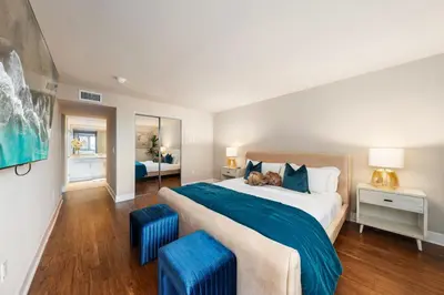 a bedroom with a large bed with a dog laying on it at Azure Marina Luxe - Waterfront with Sunset Views in Los Angeles