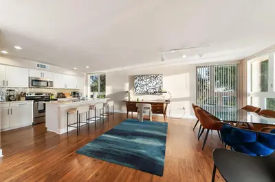 a kitchen and living room with a table and chairs at Azure Marina Luxe - Waterfront with Sunset Views in Los Angeles