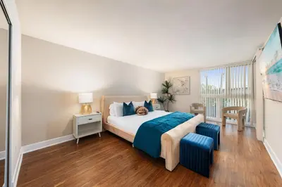 a bedroom with a large bed with a dog sitting on it at Azure Marina Luxe - Waterfront with Sunset Views in Los Angeles