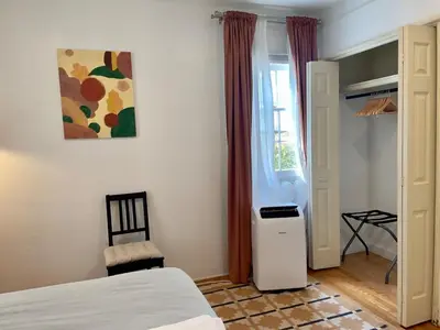 a bedroom with a bed and a chair and a window at Pasadena Quiet Gem with Fiber Internet WiFi and Workspace in Pasadena
