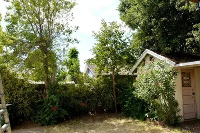 a small white house with trees and bushes at Pasadena Quiet Gem with Fiber Internet WiFi and Workspace in Pasadena