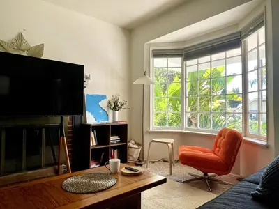 a living room with a tv and a couch and a chair at Pasadena Quiet Gem with Fiber Internet WiFi and Workspace in Pasadena