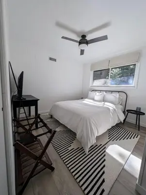 a bedroom with a bed and a ceiling fan at Fam & Pet Friendly Chalet w AC & BBQ - Top Rated in Crestline