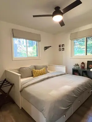 a bedroom with a large bed with a ceiling fan at Fam & Pet Friendly Chalet w AC & BBQ - Top Rated in Crestline