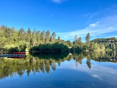 a view of a lake with a boat on it at Fam & Pet Friendly Chalet w AC & BBQ - Top Rated in Crestline