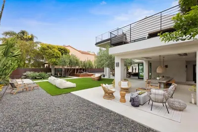 a backyard with a patio furniture and a house at The Colony Reserve by Stay Awhile Villas in Malibu Beach