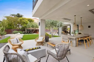 a patio with a fireplace and a table and chairs at The Colony Reserve by Stay Awhile Villas in Malibu Beach