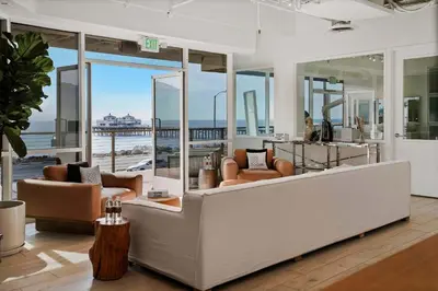 an open living room with a view of the ocean at The Hideaway Beach House by Stay Awhile Villas in Malibu Beach