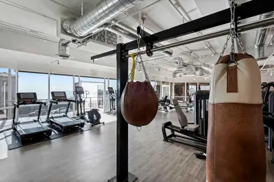 a gym with cardio equipment and exercise bikes at The Hideaway Beach House by Stay Awhile Villas in Malibu Beach