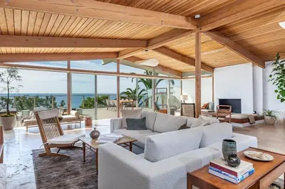a living room with a couch and a table at The Hideaway Beach House by Stay Awhile Villas in Malibu Beach