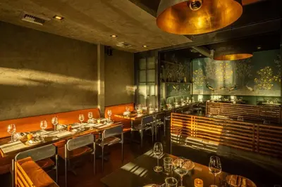 a restaurant with tables and chairs and a bar at At Hermosa Ave and Pier ave- B in Hermosa Beach