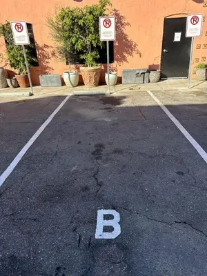 an empty parking lot with a b sign on it at At Hermosa Ave and Pier ave- B in Hermosa Beach