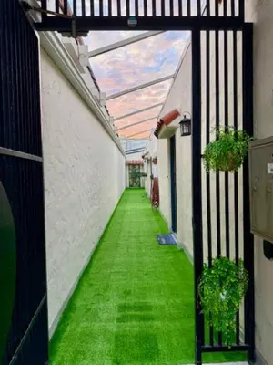an empty hallway with green grass in a building at At Hermosa Ave and Pier ave- B in Hermosa Beach