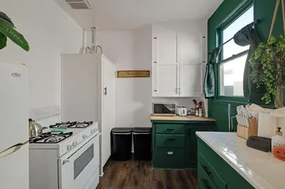 a kitchen with green cabinets and a white stove at At Hermosa Ave and Pier Ave- C in Hermosa Beach