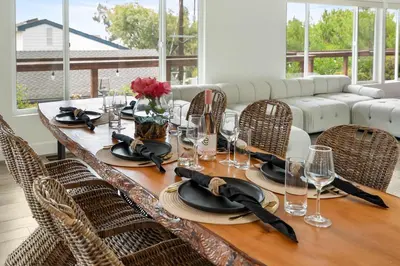 a dining room table with chairs and a table with glasses at New Listing Palisades Villa by Colby & Conrad in Los Angeles