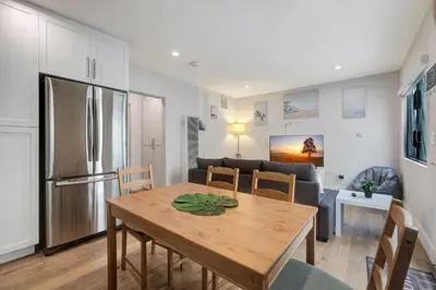 a kitchen and living room with a table and a refrigerator at Feel At Home At A One Bedroom Apt 1 Block From The Beach in Hermosa Beach