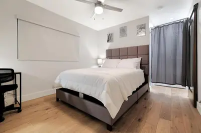 a bedroom with a large bed and a ceiling fan at Feel At Home At A One Bedroom Apt 1 Block From The Beach in Hermosa Beach