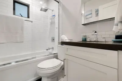 a white bathroom with a toilet and a sink at Feel At Home At A One Bedroom Apt 1 Block From The Beach in Hermosa Beach