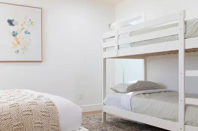a white bunk bed in a white bedroom at Grand 4-Bedroom - Brand New - Free parking and Patio in Los Angeles