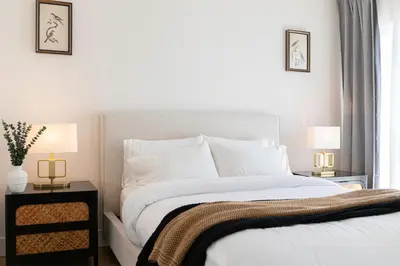 a bedroom with a white bed and two lamps at Grand 4-Bedroom - Brand New - Free parking and Patio in Los Angeles