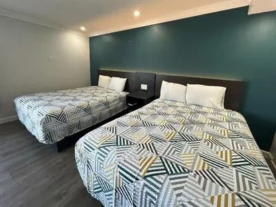 a hotel room with two beds in a room at Studio 6 Suites Buena Park CA Anahiem Near Maingate Knotts in Buena Park
