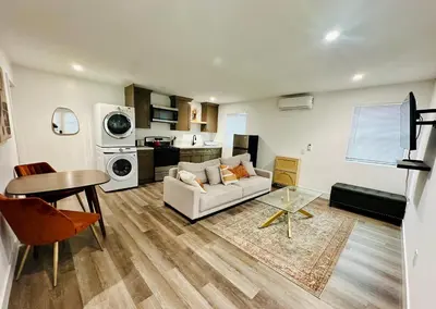 a living room with a couch and a table at Modern LA Guest House in Los Angeles