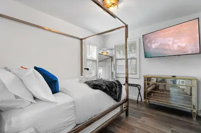 a bedroom with a bed and a dresser with a mirror at New Listing City Bungalow by Colby & Conrad in Los Angeles