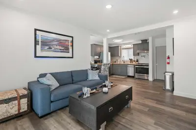 a living room with a blue couch and a table at New Listing City Bungalow by Colby & Conrad in Los Angeles