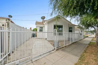 a white fence in front of a house at New Listing City Bungalow by Colby & Conrad in Los Angeles