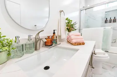 a white bathroom with a sink and a mirror at Luxury House 3-Level 4-bedroom, Free Parking and Patio in Los Angeles