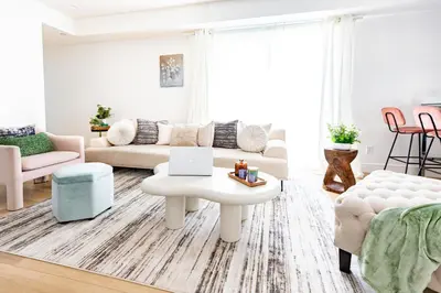 a living room with a couch and a table with a laptop on it at Luxury House 3-Level 4-bedroom, Free Parking and Patio in Los Angeles
